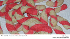 Red and white candy cane cookies on a paper towel.